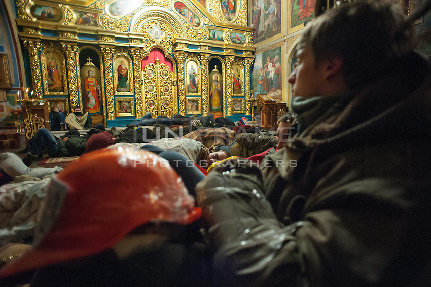People sleeping in Mykhailovskyi Monastery, which allowed protestors to sleep during cold winter nights in Kiev and hide from attack of riot police. The Kiev patriarchy widely supports the protesters and opens door of all temples for those who do not have place to sleep. Traditionally Kiev patriarchy is opposed by pro-Russian Russian Patriarchy, which has not made any statements for now.