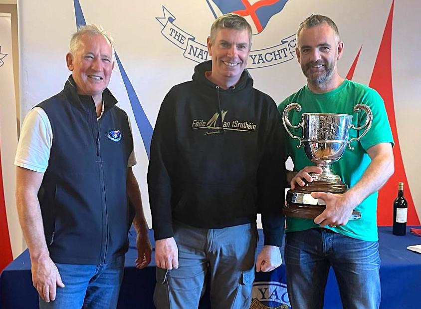 National Yacht Club Commodore Peter Sherry (left), a competitor himself, presents the Flying Fifteen Championships of Ireland Trophy to Connemara's Niall O'Brien and Ronan O'Briain.