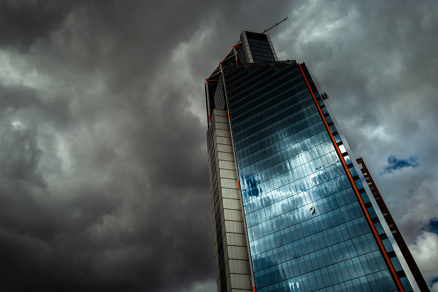 A Colombian window cleaner works outside the Atrio North Tower building before the rainstorm in Bogotá, Colombia, 24 October 2019.