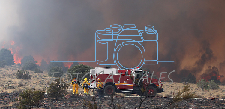 Firefighters battle a 150-acre fire near Holbrook Junction, Nev., on Saturday, Sept. 10, 2011. Dozens of homes were initially threatened but firefighters have caught the fire and an estimated 250 personnel are on scene..Photo by Cathleen Allison