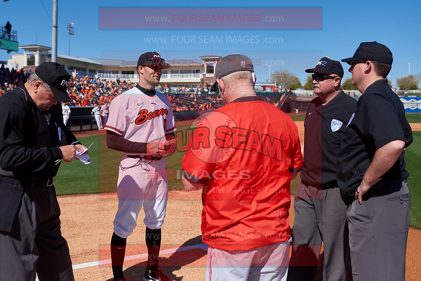 Oregon State Beavers manager Mitch Canham (11) meets with New Mexico head coach Ray Birmingham and the umpire crew before an NCAA game against the New Mexico Lobos at Surprise Stadium on February 14, 2020 in Surprise, Arizona. (Zachary Lucy / Four Seam Images)