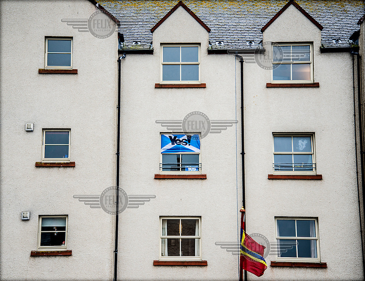 A Scottish flag with the word 'Yes!' is displayed in a window on Harbour Street in Kirkwall, the capital of the Orkney Islands. The 'Yes' campaign is calling for Scottish people to vote in favour of seceding from the United Kingdom and becoming an independent country in a referendum held on 18 September 2014.