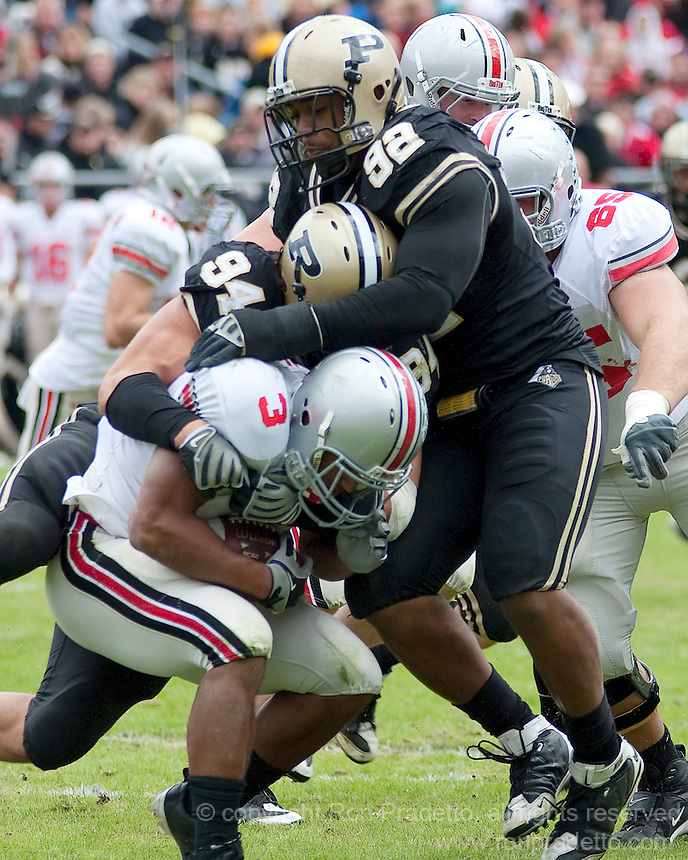 Purdue defensive end Ryan Kerrigan (94) and defensive tackle Mike Neal (92) make a tackle on Ohio State running back Brandon Saine (3). The Purdue Boilermakers defeated the Ohio State Buckeyes 26-18 at Ross-Ade Stadium, West Lafayette, Indiana on October 17, 2009..