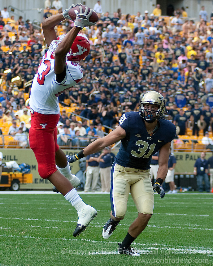 Youngstown State wide receiver Aaron Pitts makes a catch in front of Pitt defensive back Dom DeCicco (31). The Pittsburgh Panthers defeated the Youngstown State Penguins 38-3 at Heinz Field on September 5, 2009.