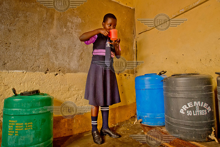 A student at the Special Care Junior School, in the district of Kanyanya, drinks water produced by the school's Solvatten solar water purifier with water. The school purchased the device to be able to offer their pupils potable drinking water.