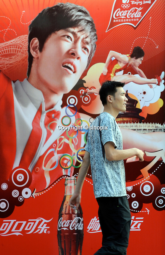 A Coca-cola advert featuring Chinese 110 meters hurdler Liu Xiang on an advertising hoarding outside Chaoyang Park, where the beach volley is being played. After years of hype and multi-million dollar endorsements Liu Xiang disappointed the whole of China and failed before the first hurdle and is out of the games with injury..