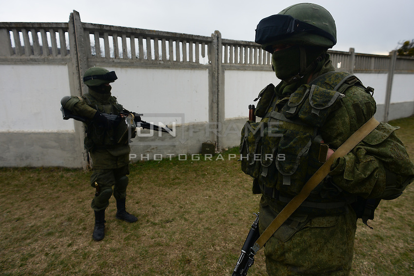 Soldiers in Russian uniform secures the perimeter of the occupied Ukrainian military base in Perevalnoe