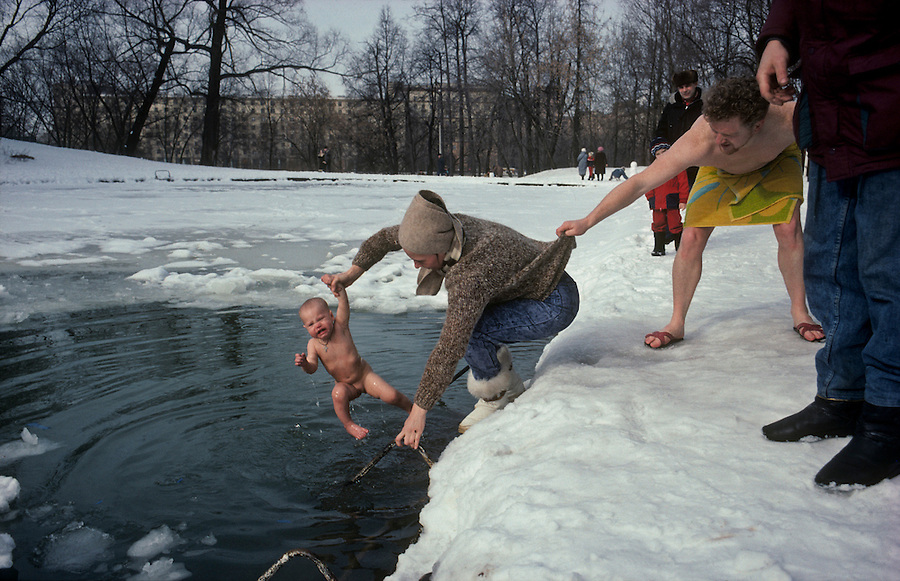 Gorky Park, Moscow, Russia..The Maxim Gorky Central Park of Culture and Rest was the first such park in the Soviet Union, and it remains the largest in Russia; some 10 million people visit each year. A group of ice swimmers, known as walruses, dip a baby girl in a park lake in temperatures of minus 18C.