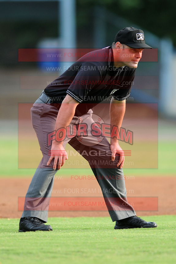 First base umpire Scott Costello during a game against the Augusta GreenJackets and the Asheville Tourists at McCormick Field on June 27, 2013 in Asheville, North Carolina. The Tourists won the game 10-6. (Tony Farlow/Four Seam Images)