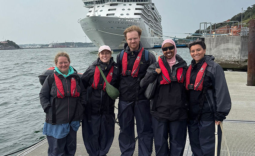 Travel journalists from Britain with Emma Sturt, FINN Partners (right), before taking a boat trip from Cobh. Also above is the cruise ship Seven Seas Grandeur, which, as Afloat previously reported, is visiting Greencastle (Lough Foyle), Co. Donegal, with a call today, 21 August. 