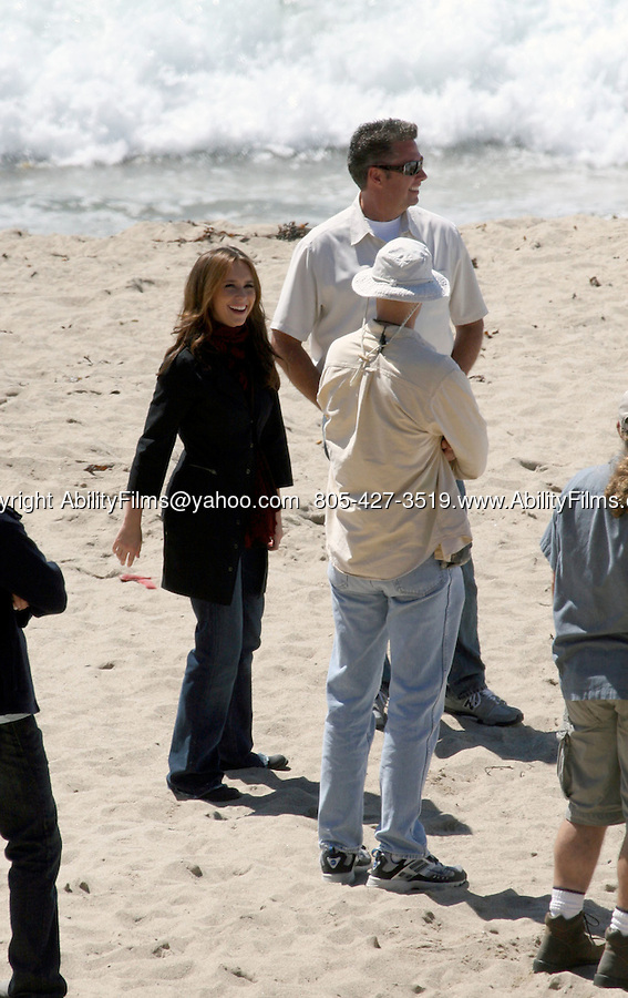 AbilityFilms@yahoo.com 805-427-3519.www.AbilityFilms.com.9-10-07 monday Jennifer Love Hewitt stretching on the beach in Malibu inbetween takes while filming the tv show Ghost Whisperer. She also was carrying around music notes and a guitar case.