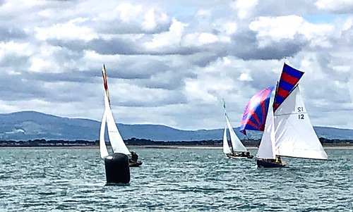 Summertime sailing on the Fingal coast. The 1907-vintage Howth 17 Rosemary, built by James Kelly of Portrush and owned since 1974 by David Jones and George Curley with David Potter a more recent additional partner, comes to the lee mark under spinnaker in third place in one of Saturday’s four races. After the completion of the five-race series, Rosemary was Howth 17 National Champion for the first time 