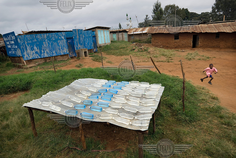 Water bottles sit out in the sun in the Kibera slums. Many diseases in developing countries are a direct or indirect result of drinking dirty water. One simple solution to this health problem may be an initiative by a Swiss researcher, Martin Wegelin, who is convinced that sunlight (UV radiation) can kill most bacterials. He claims one day of exposure to sunlight makes the water from a plastic bottle bacteria free..