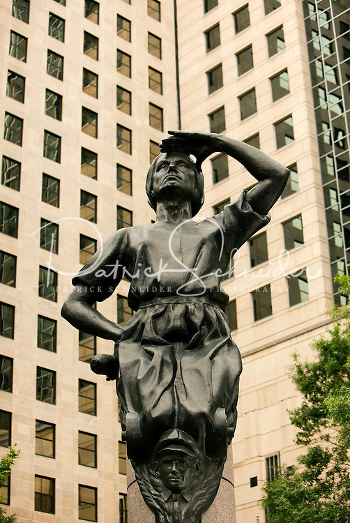 The city of Charlotte has four statues on the corners of the main square of the city, the corners of Trade Street and Tryon Street. This figure, of a mill worker wearing a bonnet, represents Industry. The three other statues represent Transportation, Future and Commerce. American sculptor Raymond Kaskey created the four public art statues. Some people say the child peeking out from beneath her skirt represents child labor in the past.