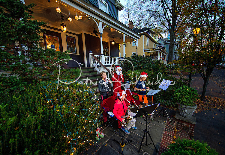 Young neighborhood children playing their musical instruments entertain the passing crowds with Christmas music, at the annual Fourth Ward Holiday Home Tour in Uptown Charlotte, North Carolina. This walkable, self-guided tour allows visitors to get into the Christmas holiday spirit while checking out the beautifully decorated home in Charlotte's historic Fourth Ward. <br />
<br />
Charlotte Photographer - PatrickSchneiderPhoto.com