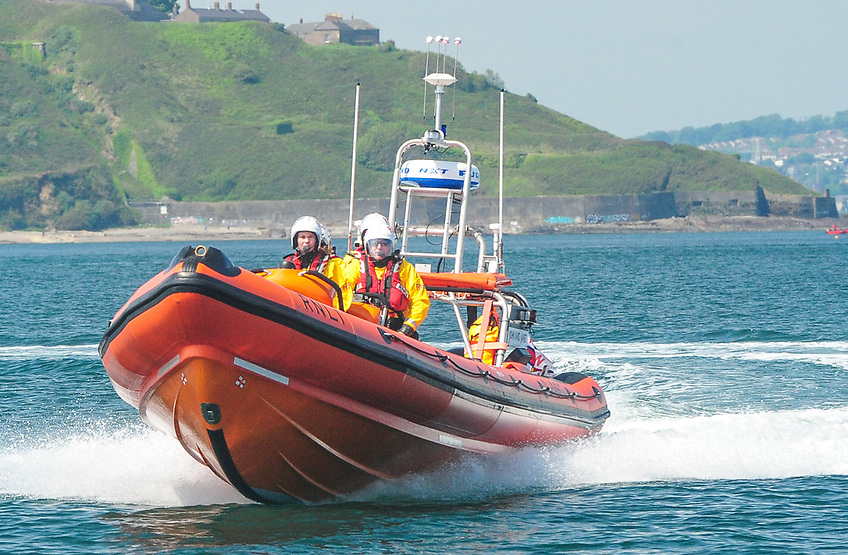 RNLI lifeboat crew members assist a dismasted yacht near Whitegate refinery, ensuring the safety of five sailors on board.