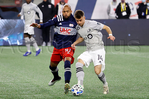 20th November 2020; Foxborough, MA, USA; Montreal Impact midfielder Amarettos Sejdic plays the ball away from New England Revolution midfielder Teal Bunbury (10) during the MLS Cup Play-In game between the New England Revolution and the Montreal Impact