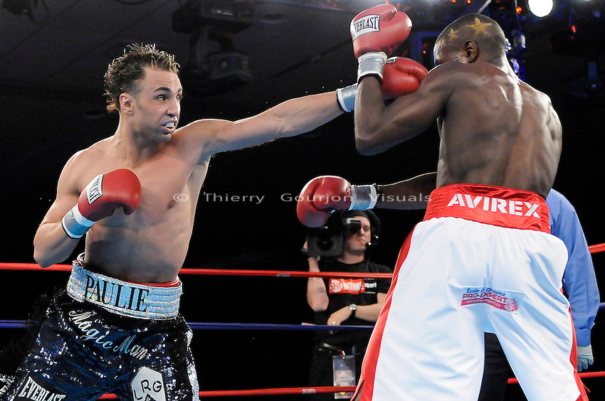 Atlantic City, N.J: Paulie Malignaggi (black trunk) on the attack against Herman Ngoudjo (white trunk) during their 12 rounds IBF Junior Welterweight Championship fight at the Bally's hotel casino on Saturday 5th, 2008..Malignaggi held on to his title by unanimous decision. It was his first defense since winning the belt over Lovemore Ndou in 2007. Photo by Thierry Gourjon.
