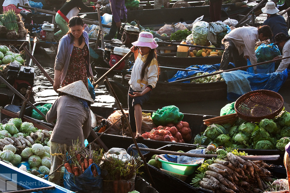 Robert Dodge, a Washington DC photographer and writer, has been working on his Vietnam Unexpected project since 2005. The project has taken him throughout Vietnam, including Hanoi, Ho Chi Minh City (Saigon), Nha Trang, Mue Nie, Phan Thiet, the Mekong, Sapa, Ninh Binh and the Perfume Pagoda. His images capture scenes and people from women in conical hats planting rice along the Red River in the north to men and women working in the floating markets one the Mekong River and its tributaries. Robert's project also captures the traditions of ancient Asia in the rural markets, Buddhist Monasteries and the celebrations around Tet, the Lunar New Year. Also to be found are images of the emerging modern Vietnam, such as young people eating and drinking and embracing the fashions and music of the west. Robert Dodge, a Washington DC photographer and writer, has been working on his Vietnam Unexpected project since 2005. The project has taken him throughout Vietnam, including Hanoi, Ho Chi Minh City (Saigon), Nha Trang, Mue Nie, Phan Thiet, the Mekong, Sapa, Ninh Binh and the Perfume Pagoda. His images capture scenes and people from women in conical hats planting rice along the Red River in the north to men and women working in the floating markets one the Mekong River and its tributaries. Robert's project also captures the traditions of ancient Asia in the rural markets, Buddhist Monasteries and the celebrations around Tet, the Lunar New Year. Also to be found are images of the emerging modern Vietnam, such as young people eating and drinking and embracing the fashions and music of the west.