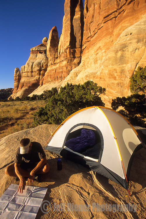 A young man camps in the Needles District of Canyonlands National Park, Utah.