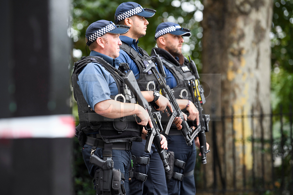 © Licensed to London News Pictures. 14/08/2018. London, UK. Armed police stand at a police cordon near where a car rammed the security barriers at the Houses of Parliament in London. It has been reported that pedestrians were hit by the car. Photo credit: Ben Cawthra/LNP