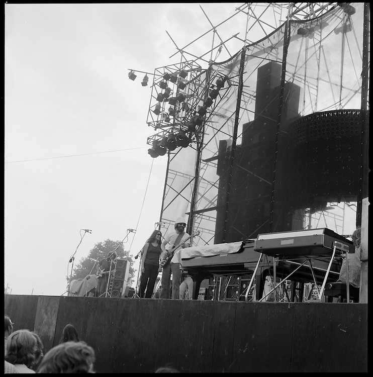 The Grateful Dead Concert at Dillon Stadium on 31 July 1974. Shot this photo at the very beginning of the first set. I think someone bumped my elbow when the shutter clicked, this shot is a bit skewed. B&W Original Film Scan. Photograph taken with a Hasselblad Camera with Tri-X film. This photograph can be straightened and cropped though I wish to show the full camera capture of all 12 of these medium format photos.