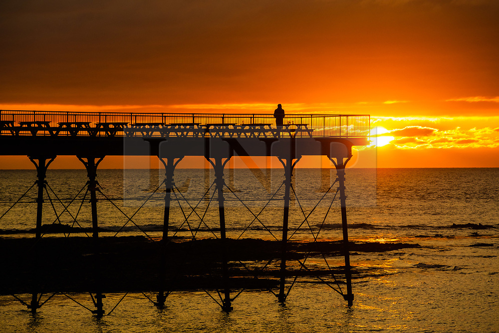 ©Licensed to London News Pictures. 16/09/2019 Aberystwyth UK. <br />
A man standing on Aberystwyth’s Victorian seaside pier is silhouetted as he watches the last rays of the suns as it sets over Cardigan Bay, on a glorious mid autumn evening, The week ahead is expected to be warm and settled with a high pressure system dominating the weather in the southern parts of the UK. Photo credit Keith Morris/LNP
