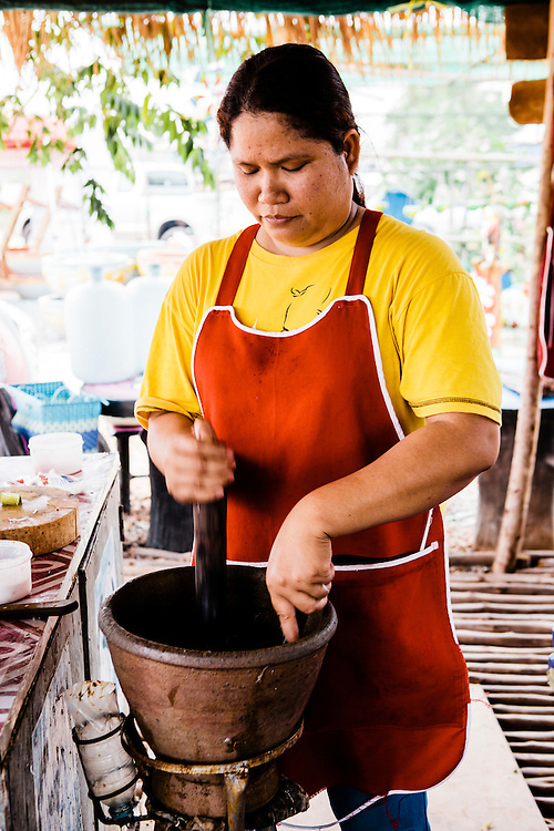 Making som tam (papaya salad) with saak (mortar) and krok (pestle), Udon Thani