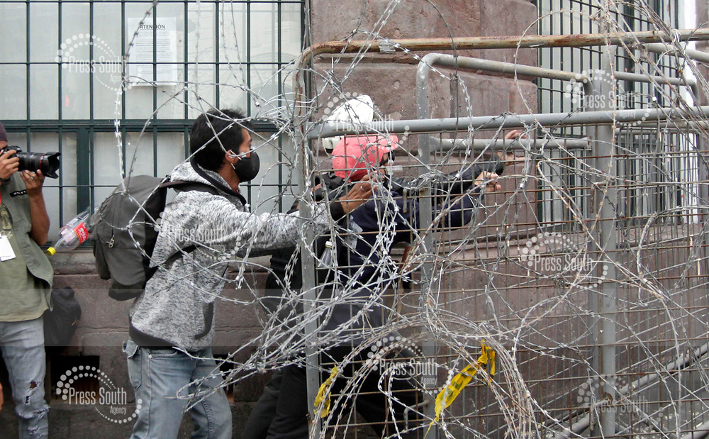 QUITO, ECUADOR - OCTOBER 01: Persons break the police security fences on the outskirts of the government palace during the protests against the government of President Lenin Moreno on October 1, 2020 in Quito, Ecuador. Ecuador faces social unrest amid the coronavirus pandemic as aresult of the tight budget for education and the layoff of teachers. Different organizations joined the protests as well as students. (Photo by Carlos Arias/Agencia Press South/Getty Images)