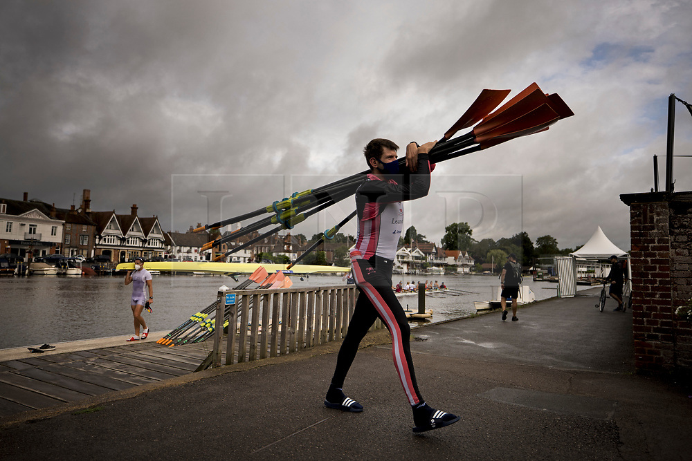 © Licensed to London News Pictures. 09/08/2021. Henley-on-Thames, UK. Rowers leave the water after training in the rain, underneath grey skies, ahead of the the Henley Royal Regatta which starts on Wednesday, set on the River Thames by the town of Henley-on-Thames in Oxfordshire, England. Established in 1839, the five day international rowing event, raced over a course of 2,112 meters (1 mile 550 yards), is considered an important part of the English social season. Photo credit: Ben Cawthra/LNP