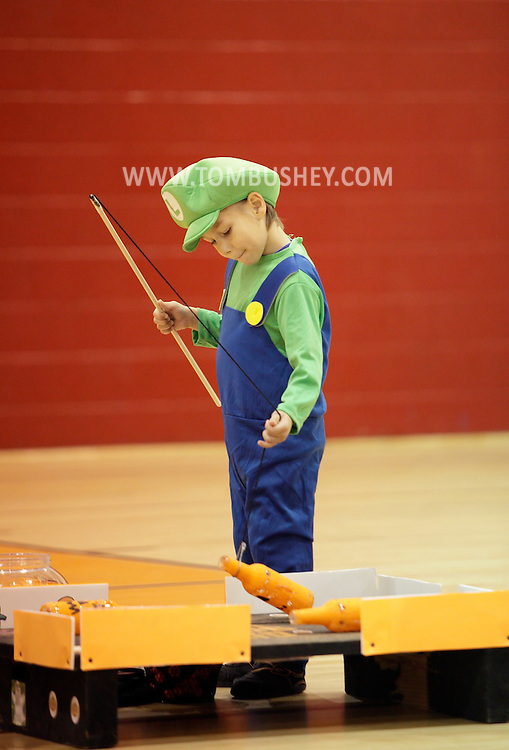 Middletown, New York - A boys wearing a costume plays a game in the gymnasium during the Middletown YMCA Family Fall Festival on Oct. 29, 2011.