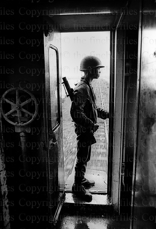 A south Vietnamese army soldier stands guard on the train between Hue and Da Nang in Vietnam, September 1969. The Vietnam War was fought between 1st November 1955 until the fall of Saigon on 30 April 1975. Photographed by Terry Fincher.