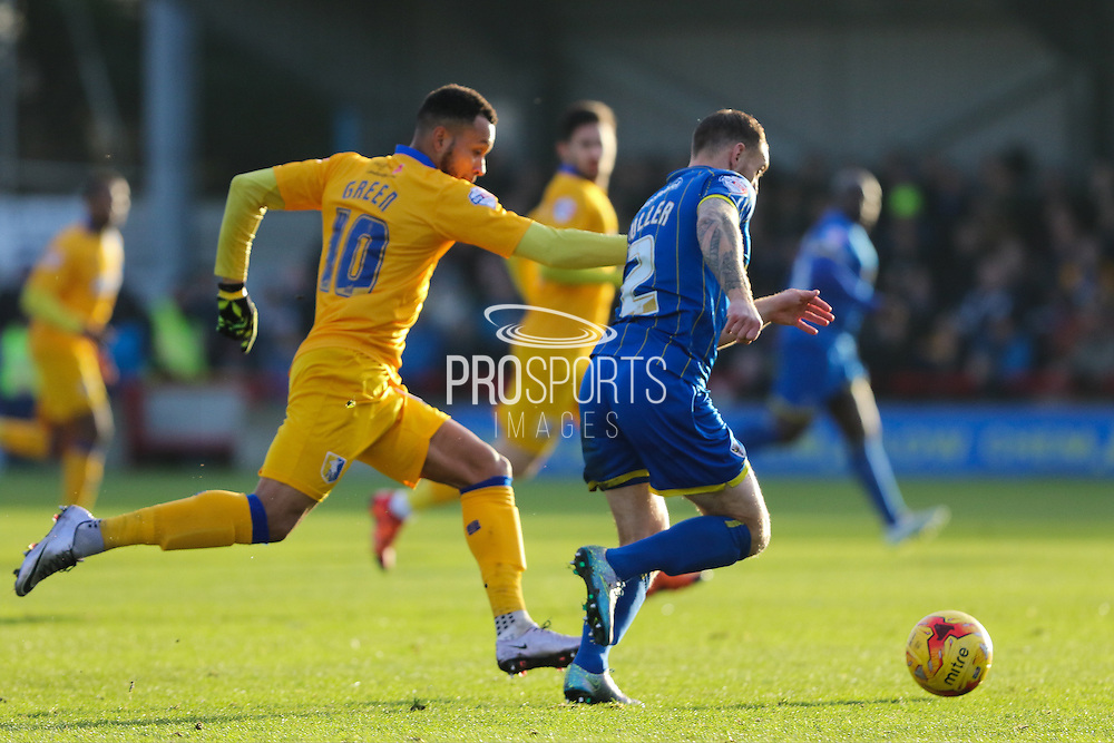 Barry Fuller (Captain) of AFC Wimbledon beats Matt Green of Mansfield Town to the ball during the Sky Bet League 2 match between AFC Wimbledon and Mansfield Town at the Cherry Red Records Stadium, Kingston, England on 16 January 2016. Photo by Stuart Butcher.
