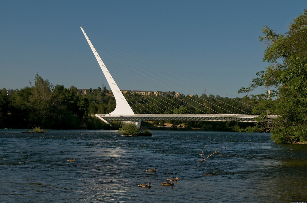 Architect Santiago Calatrava designed the Sundial Bridge in Redding. the $23 million footbridge It crosses the Sacramento River and never touches the water. ..The Sacramento River, California's largest river flowing 375 miles, from Mount Shasta in the north through the Central Valley and the Delta to San Francisco Bay, this river constitutes an irreplaceable resource to Northern California's ecology...Boating, fishing, camping and swimming on the Sacramento and its reservoirs attract more than 8 million visitors a year. ..The 21-mile stretch from Redding to Balls Ferry is perfect for scenic touring and shorter trips. For the adventuresome, the breath-taking 33-mile stretch between Balls Ferry and Red Bluff is your ticket...The Sundial Bridge is actually a working Sundial is 700 feet long, 23 feet wide and 217 feet high (pylon). The bridge weighs 3.2 million pounds (1,600 tons) and is composed of steel with galvanized steel cables. The deck materials are non-skid glass panels in steel framework with granite accents. The foundation consists of 115 tons of rebar, 1,900 cubic yards of concrete and a superstructure of 400 tons of steel. 200 tons of glass and granite were utilized in deck construction. The bridge contains 4,342 feet of cable and the pylon is 580 tons of steel.