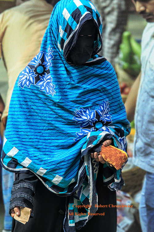 Fashion of Oppression: This woman shops the morning market wearing her burka, the fashion of her oppression; both condoned and promoted by her social and religious standing, Dhaka Bangladesh.
