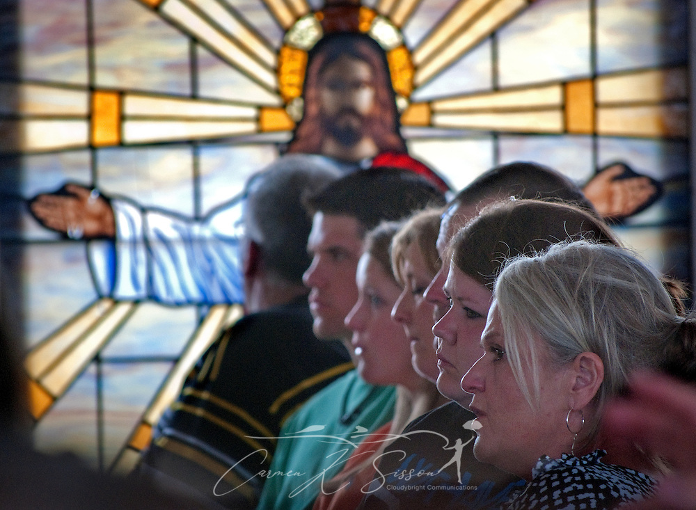 A stained glass window depicting Jesus Christ with outstretched hands watches over members of Smithville Baptist Church during an outdoor worship service May 1, 2011 in Smithville, Miss. The window was one of the few things recovered from the church, which was destroyed -- along with most of the town -- by an EF5 tornado last week. (Photo by Carmen K. Sisson/Cloudybright)