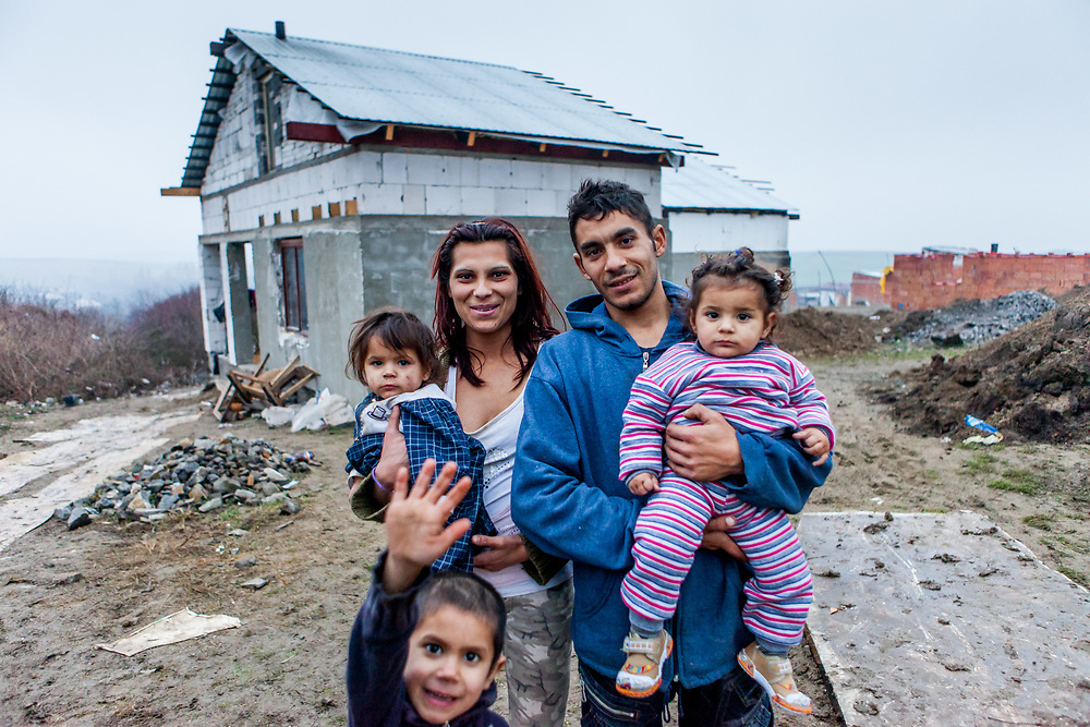 Rudo (25) and his wife Maria (22) with their daughters and son Kevin in front of their new home. The family is among those who joined the micro loan program in Rankovce to built themselves their own house with the support of the NGO ETP Slovakia. Self-construction helps to demolish stereotyped views about people from socially excluded communities, whom the majority population regards as abusers of social benefits, socially dependent, incapable, passive and constantly reliant upon state assistance. The approach gives people the opportunity to take care of themselves.