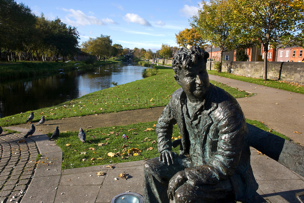 Bronze casting of writer Brendan Behan, on the Royal Canal, Dublin, by sculptore John Coll. The bench and statue are near Mountjoy Prison, where Behan spent time; his play, the Quare Fellow, features a song called "The Auld Triangle" which mentions the Royal Canal. The casting features triangles...