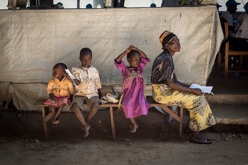 DRC / Burundi Refugees / A woman waits to be registered by UNHCR registration teams at Kavimvira transit<br />
centre in Uvira, DRC's South Kivu Province.<br />
700 vulnerable Burundian refugees are hosted in Kavimvira transit centre. The<br />
majority are women and children.<br />
<br />
More than 9000 Burundians refugees have crossed into the DRC over the past few weeks. The new<br />
arrivals are being hosted by local families, but the growing numbers are straining<br />
available support. UNHCR is helping some 700 vulnerable refugees at a transit centre<br />
at Kavimvira and in another centre at Sange. Work is ongoing to identify a site<br />
where all the refugees can be moved, and from where they can have access to<br />
facilities such as schools, health centers and with proper security. / UNHCR / F.Scoppa / May 2015