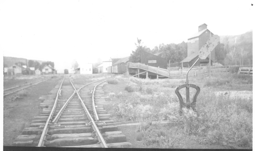 View south in Dolores showing granary and RGS cattle stockade.<br />
RGS Dolores, CO Taken by Kelley, Frank O. - ? 8/27/1948<br />
In book "Rio Grande Southern II, The: An Ultimate Pictorial Study" page 314<br />
This photo is horizontally flipped in Dorman's book.<br />
Also in "RGS Story Vol. VIII", p. 43 where it is dated as 8/26/1948.