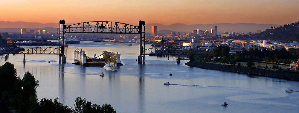 Dry dock #4 is floated down the Willamette River from its former Oregon Shipyard home to an eventual new spot in the Jamaica.