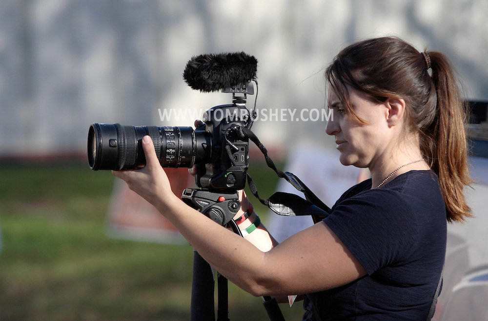 Middletown, New York - A female photojournalist shoots video with a digital single lens reflex camera during a forum with Republican gubernatorial candidate Carl Paladino hosted by the Orange/Sullivan County 912 Tea Party in the parking lot outside party headquarters on Oct. 9, 2010.