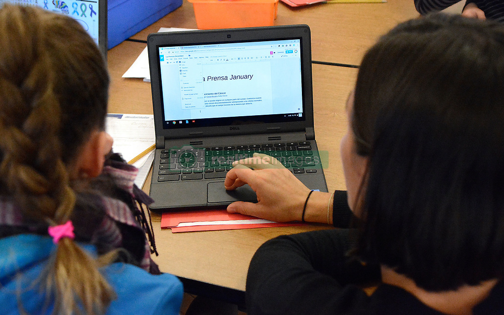 January 18, 2018 - Albuquerque, NM, U.S. - Newspaper advisor and teacher Lauren Gutierrez(right) helps one of her reporters Cienna Mazotti on her laptop as she works on a story for La Prensa, a dual language newspaper writer and published at Coronado Elementary School, a dual language school in downtown Albuquerque. Thursday Jan. 18, 2018. (Credit Image: © Jim Thompson/Albuquerque Journal via ZUMA Wire)