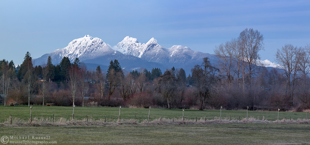 Post sunset view of Golden Ears (Mount Blanshard) and the trees along the Fraser River in Langley, British Columbia, Canada. Photographed from Derby Reach Regional Park at Meunch Bar.