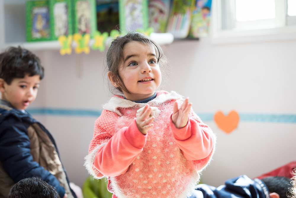 17 February 2020, Zarqa, Jordan: A girl claps her hands in 'the nanny room' at the Lutheran World Federation community centre in Zarqa. Through a variety of activities, the Lutheran World Federation community centre in Zarqa serves to offer psychosocial support and strengthen social cohesion between Syrian, Iraqi and other refugees in Jordan and their host communities.