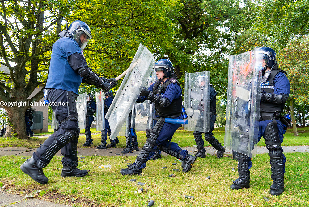 South Queensferry,, Scotland, UK. 16th September 2021. Police Scotland invite the press to witness their ongoing public order training at Craigiehall Camp at South Queensferry. The training is designed to prepare police for the upcoming COP26 event in Glasgow in November where protests are anticipated. Police in riot gear faced up against police taking the role of protesters throwing missiles and attacking them with clubs. Pic; Police taking role of Protesters attack riot police during training. Iain Masterton/Alamy Live News.