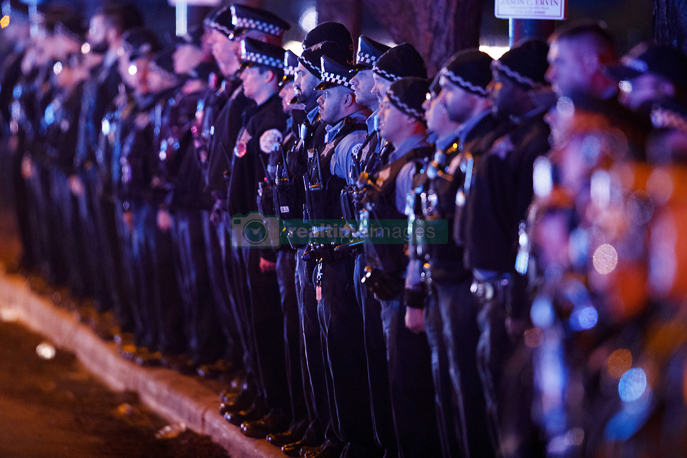 December 18, 2018 - Chicago, Illinois, USA - Members of the police department wait for the bodies of two officers who were killed Monday night while pursuing a suspect and struck by a South Shore train near 103rd Street and Dauphin Avenue to arrive at the medical examiner's office in Chicago, Ill. (Credit Image: © Armando L. Sanchez/Chicago Tribune/TNS via ZUMA Wire)