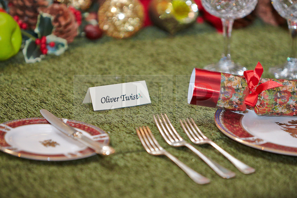 © Licensed to London News Pictures. 09/11/2013. WOODSTOCK, UK. A place setting for Oliver Twist on the grand Saloon table at Blenheim Palace. The table is set for a feast inspired by the classic story A Christmas Carol during as part of a Dickensian Christmas. The themed event opened to the public today (Sat 9th Nov) and runs until the 13th December. Photo credit: Cliff Hide/LNP