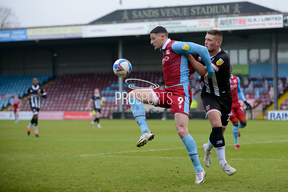 Scunthorpe United Ryan Loft (9) Grimsby Town Mattie Pollock (25) battles for possession during the EFL Sky Bet League 2 match between Scunthorpe United and Grimsby Town FC at the Sands Venue Stadium, Scunthorpe, England on 23 January 2021.