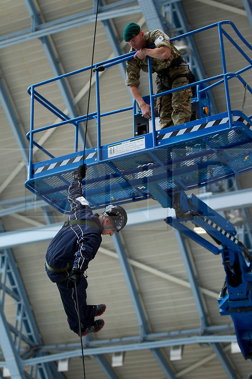© Licensed to London News Pictures. 14/09/2012. LONDON, UK. Under the instruction of a Royal Marine Commando, a volunteer abseils from the roof of St Pancras International in London today (14/09/12). The abseil saw 15 abseilers descend from the roof of the station in an attempt to raise more than £150,000 for the Commando Spirit Appeal on behalf of the Royal Marines Charitable Trust. Photo credit: Matt Cetti-Roberts/LNP